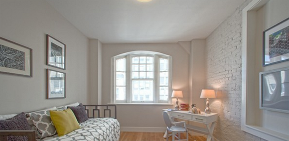 184 Joralemon Street interior showcasing exposed brick wall and arched window